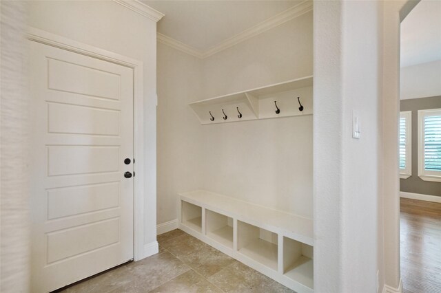 mudroom with baseboards and crown molding