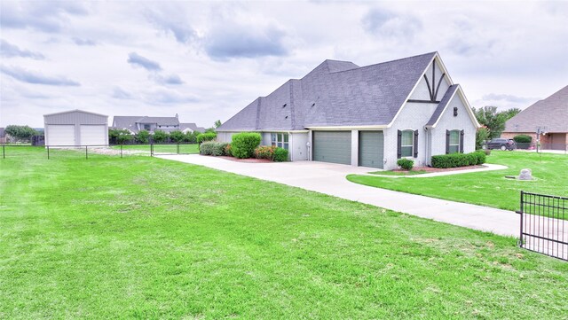 view of front facade with a garage, fence, driveway, roof with shingles, and a front lawn