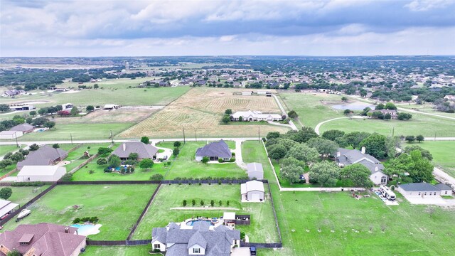 drone / aerial view featuring a residential view and a rural view