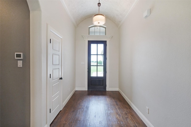 entrance foyer with lofted ceiling, arched walkways, dark wood finished floors, and baseboards