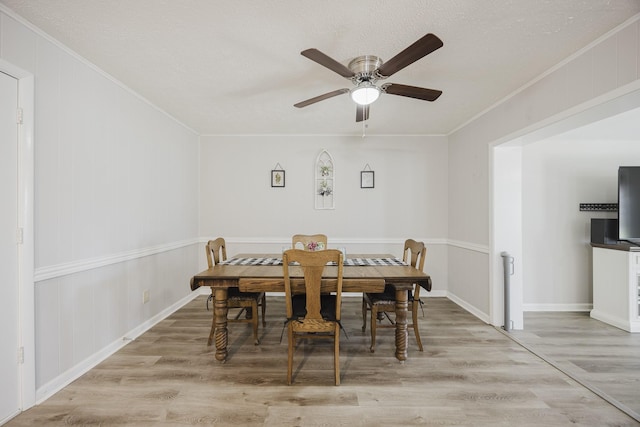 dining space with ceiling fan, light hardwood / wood-style flooring, and crown molding