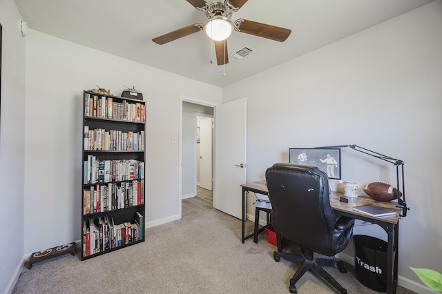 carpeted office space with ceiling fan