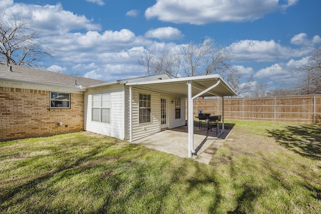 back of property featuring a lawn and a patio area