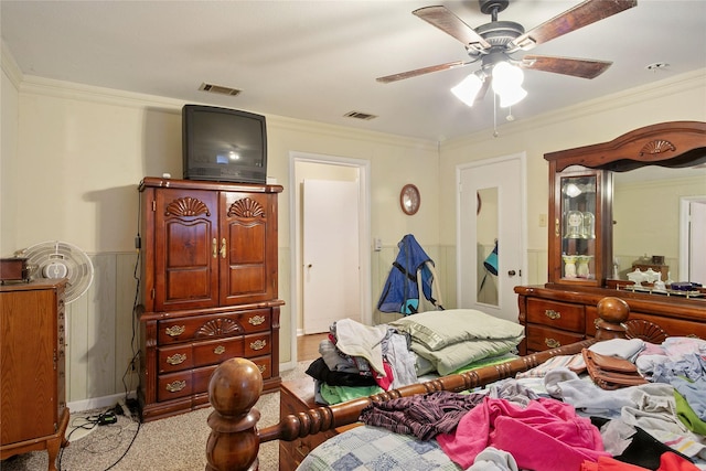 bedroom with ceiling fan and ornamental molding