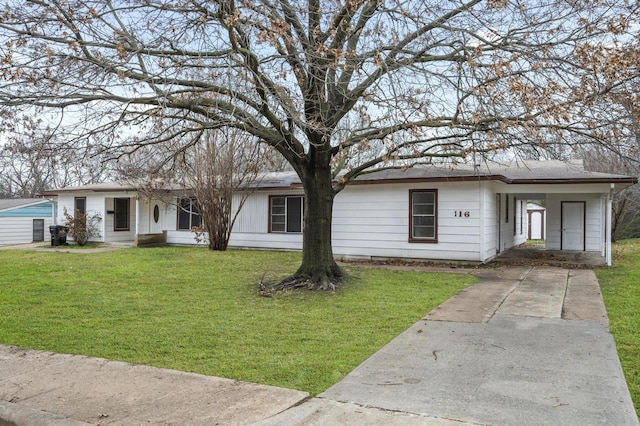 ranch-style home featuring an attached carport, concrete driveway, and a front yard