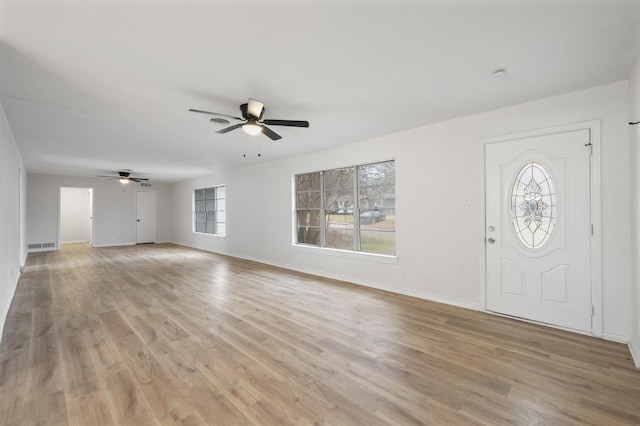 foyer entrance featuring ceiling fan, light wood finished floors, visible vents, and baseboards