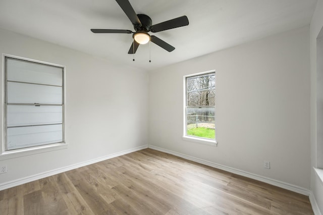 unfurnished room featuring baseboards, ceiling fan, and light wood-style floors