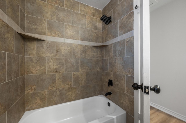 full bathroom with shower / bath combination, wood finished floors, and baseboards