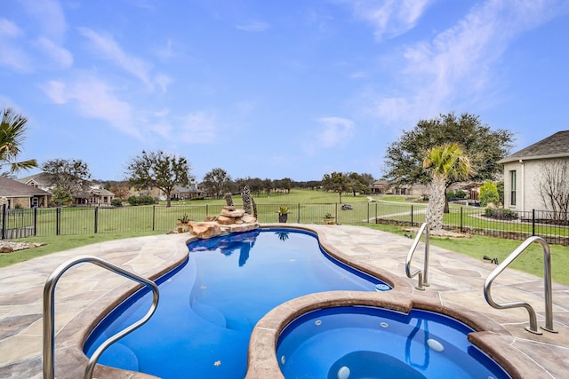 view of pool featuring a yard, a patio, a pool with connected hot tub, and fence