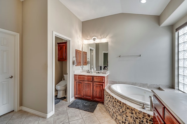 bathroom featuring tile patterned floors, toilet, a bath, vanity, and vaulted ceiling