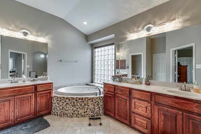 full bathroom featuring tile patterned flooring, a tub with jets, vanity, and lofted ceiling