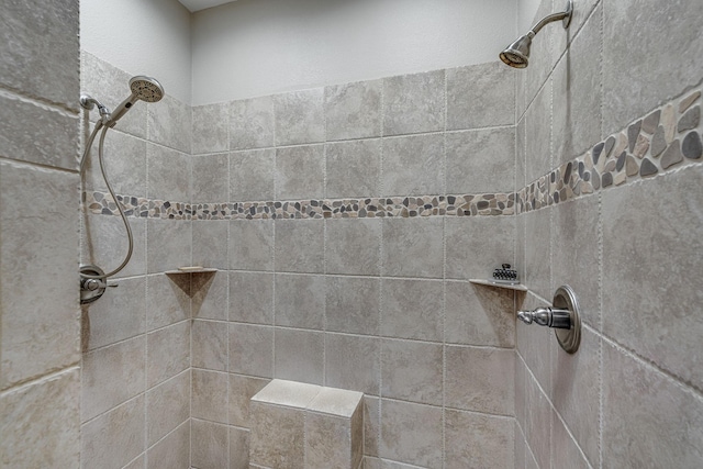 full bathroom featuring tiled shower