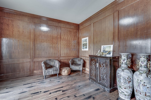 sitting room with wood finished floors and wood walls