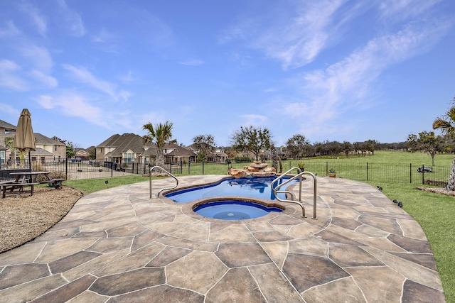 view of pool featuring an in ground hot tub, a yard, and fence