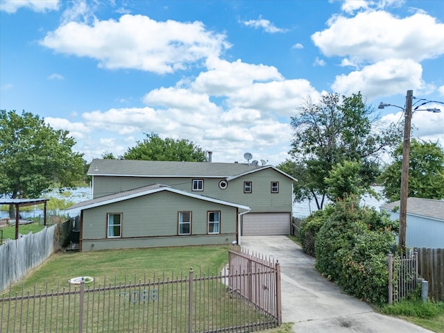 view of front of home featuring a garage and a front lawn