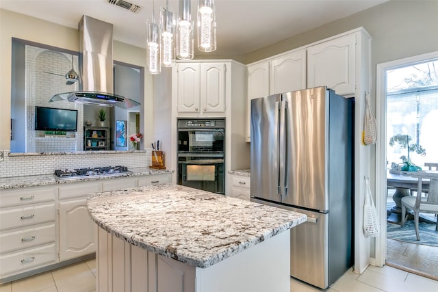 kitchen with visible vents, white cabinets, hanging light fixtures, appliances with stainless steel finishes, and island exhaust hood