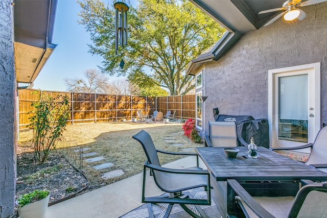 view of patio / terrace with a fenced backyard, ceiling fan, and outdoor dining space