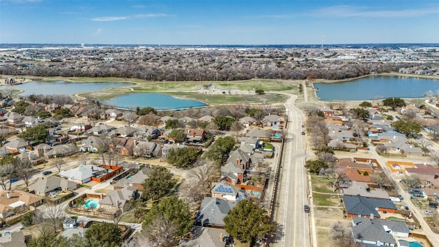 drone / aerial view with a residential view and a water view