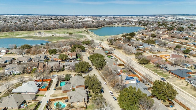 drone / aerial view with a water view and a residential view