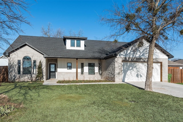 view of front of property featuring a garage and a front lawn