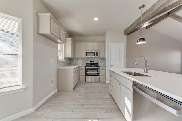 kitchen with sink, appliances with stainless steel finishes, backsplash, lofted ceiling with beams, and decorative light fixtures