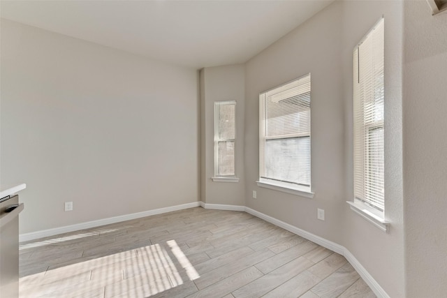 empty room with light hardwood / wood-style flooring