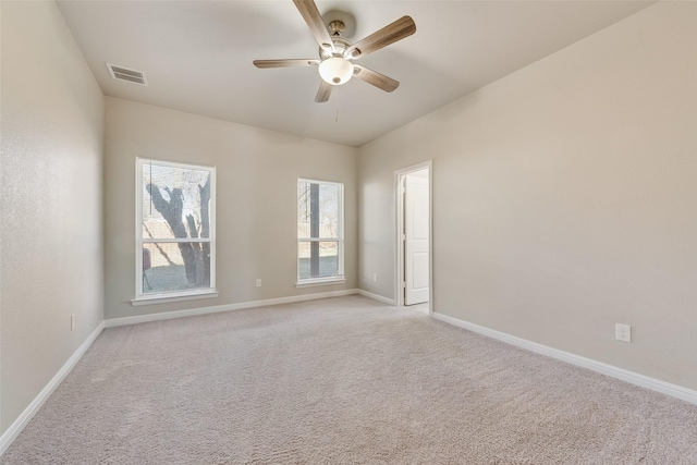 carpeted spare room with ceiling fan