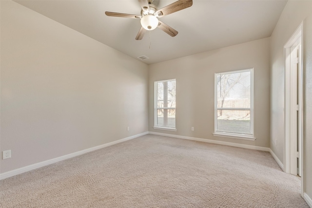 carpeted spare room featuring ceiling fan