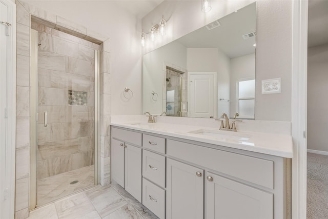 bathroom featuring vanity and a shower with shower door