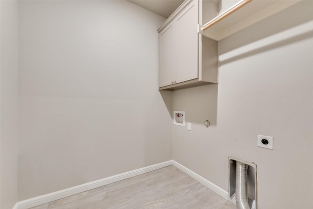 washroom featuring gas dryer hookup, cabinets, washer hookup, light hardwood / wood-style floors, and electric dryer hookup