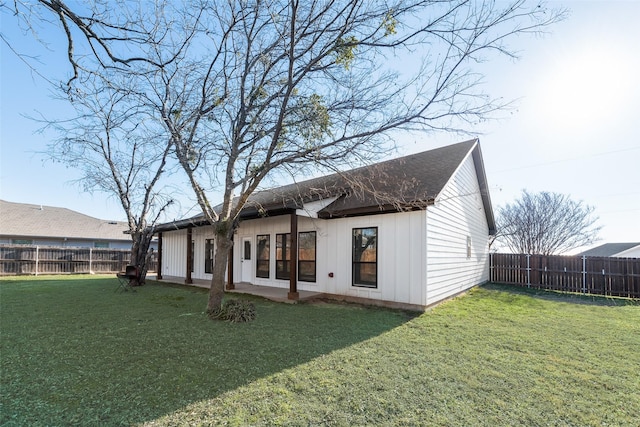 rear view of house with a yard