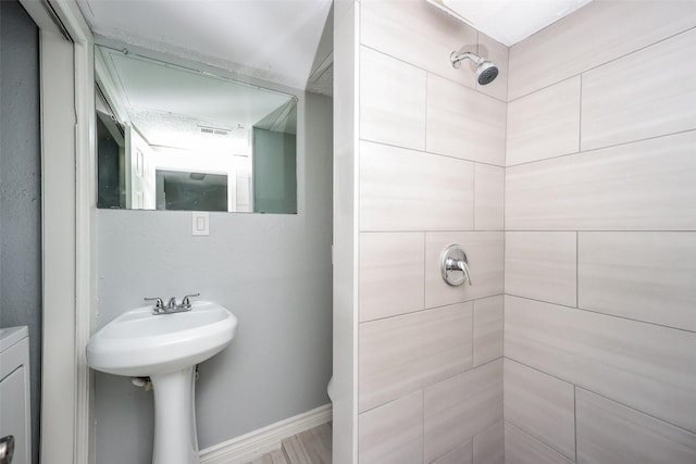 bathroom with a tile shower