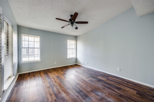 spare room with a textured ceiling, dark wood-type flooring, and ceiling fan