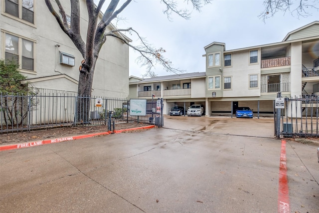 view of street featuring a gate and curbs