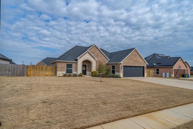 view of front of property featuring a garage and a front lawn