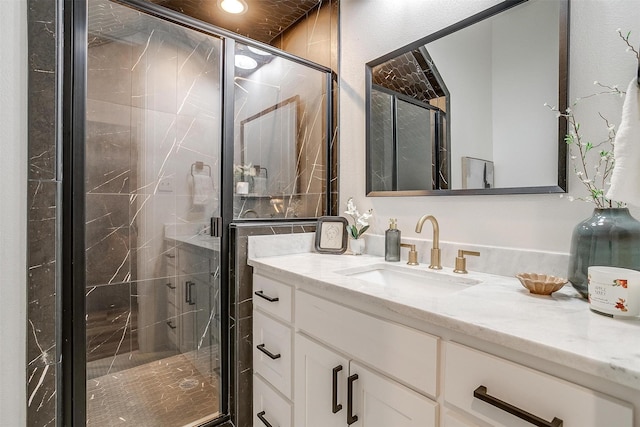 bathroom featuring vanity and an enclosed shower