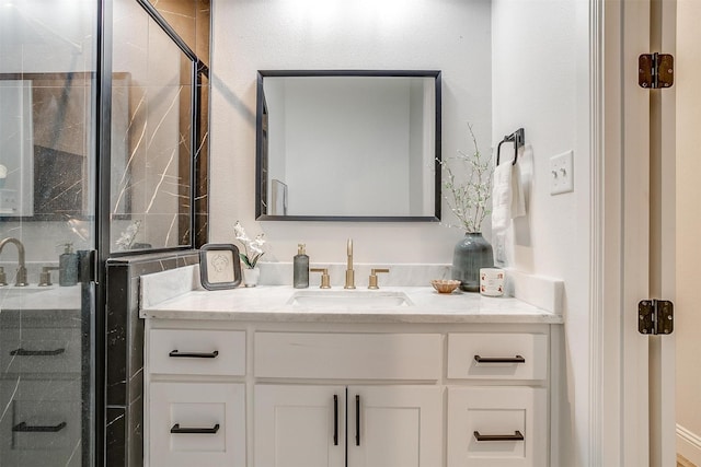 bathroom with vanity and a shower with shower door