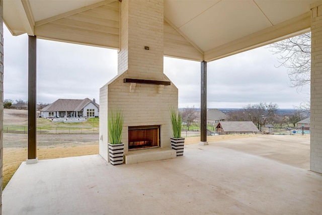 view of patio / terrace with an outdoor brick fireplace