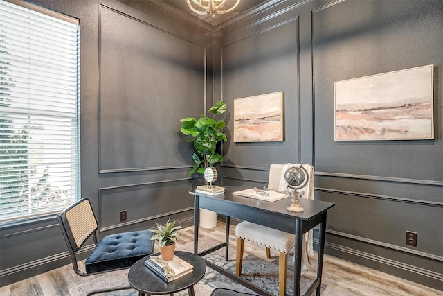 office featuring an inviting chandelier and light hardwood / wood-style floors