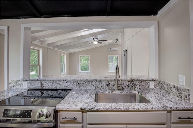 kitchen featuring sink, stainless steel range with electric stovetop, vaulted ceiling with beams, light stone counters, and white cabinets