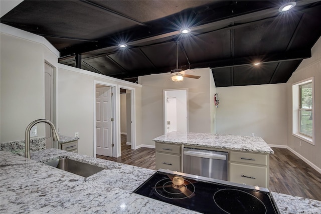 kitchen with lofted ceiling with beams, white cabinetry, light stone countertops, and sink