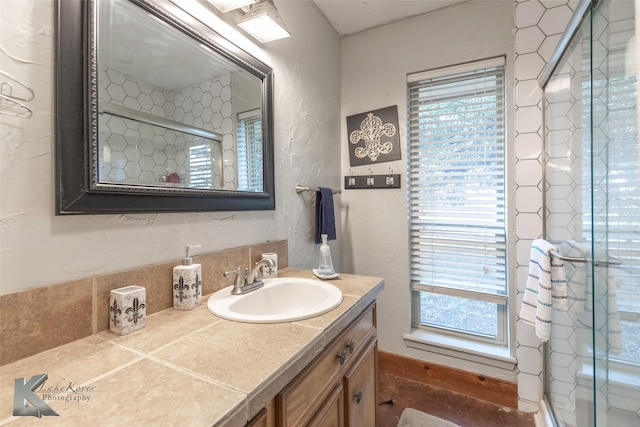 bathroom with vanity and a shower with shower door