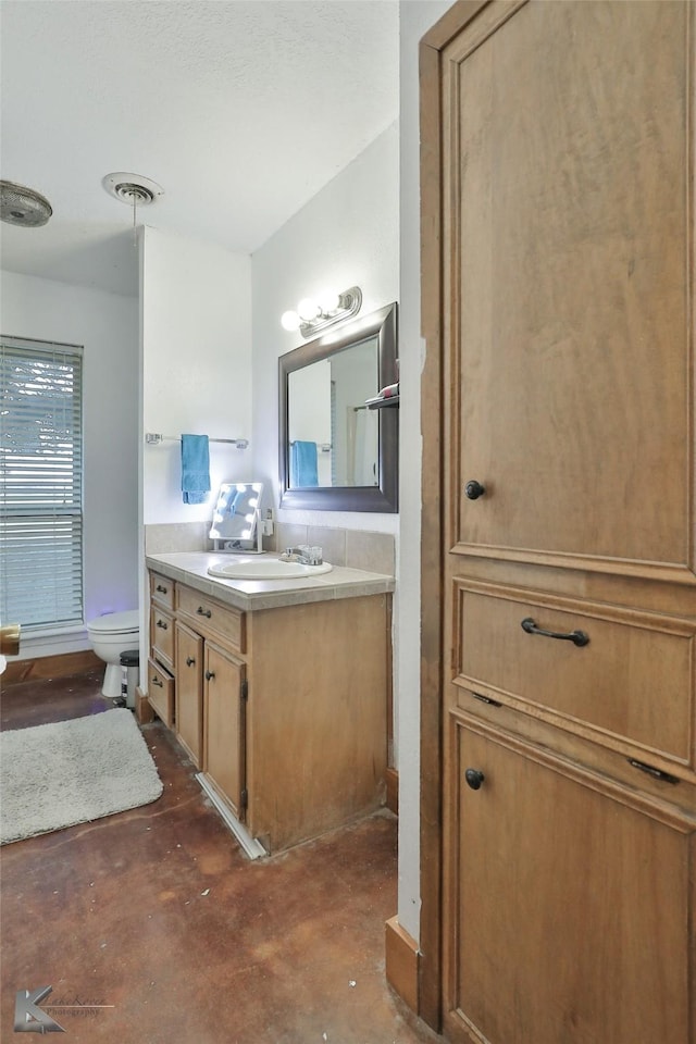 bathroom with vanity and toilet