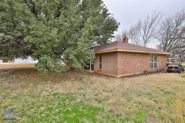 view of property exterior with a yard