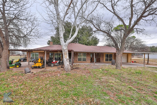 view of front of house featuring a front lawn and a patio