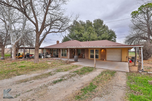 view of front of property with a garage, a porch, and a carport