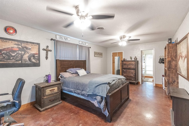 bedroom with ceiling fan and a textured ceiling