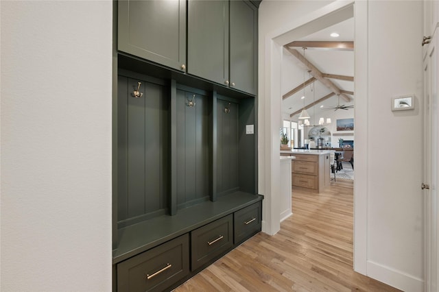 mudroom featuring light wood-style floors, vaulted ceiling with beams, baseboards, and a ceiling fan