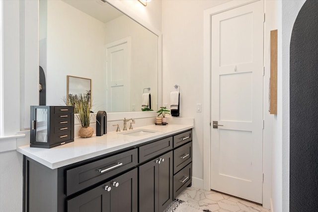 bathroom featuring marble finish floor and vanity