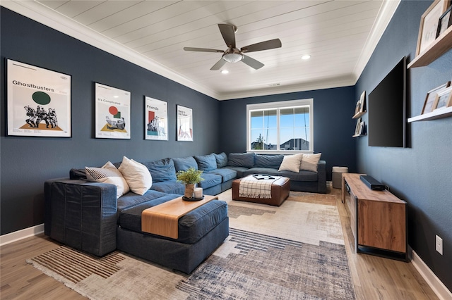 living area with a ceiling fan, light wood-type flooring, crown molding, and baseboards